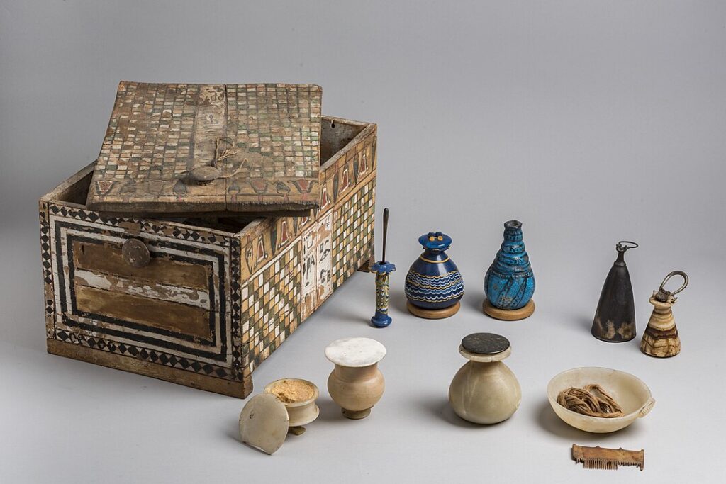 Ancient Egyptian makeup box containing cosmetic tools, kohl (eyeliner), ointment and perfume vials.