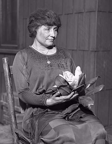 A portrait of young Helen Keller, gazing forward with a serious expression.