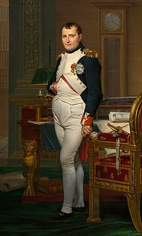 Portrait of Napoleon Bonaparte standing in his study, wearing imperial robes